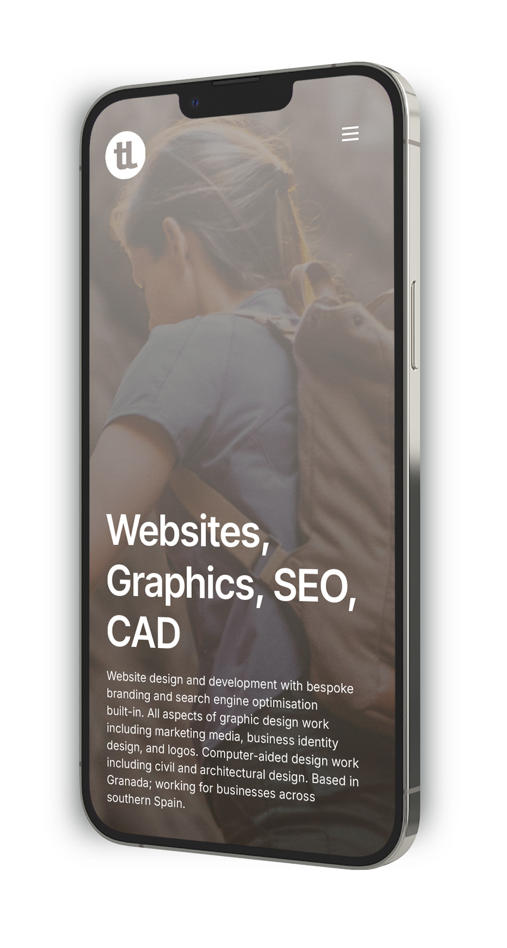 A mobile phone with the homepage of tomlumsden.es showing responsive website design